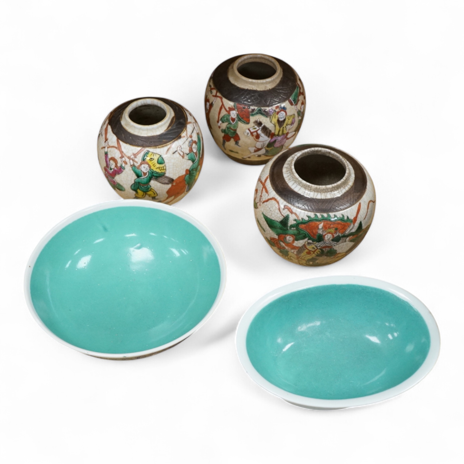 Three Chinese crackleglaze 'Warriors' jars without covers and two Chinese enamelled porcelain bowls. Largest bowl 20cm diameter.